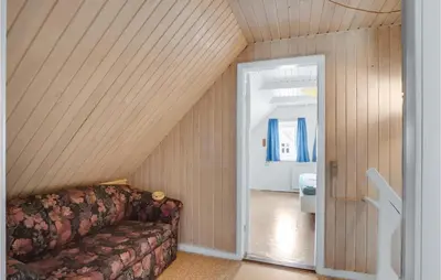 a living room with a couch in the attic at Lovely Home In Thisted With Kitchen in Thisted
