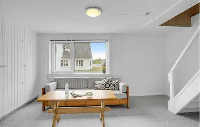a living room with a couch and a table at Lovely Home In Thisted With Kitchen in Thisted