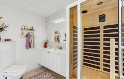 a bathroom with a toilet and a sink at Cozy Home In Thisted With Sauna in Thisted