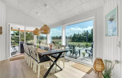 a dining room with a table and chairs at Cozy Home In Thisted With Sauna in Thisted