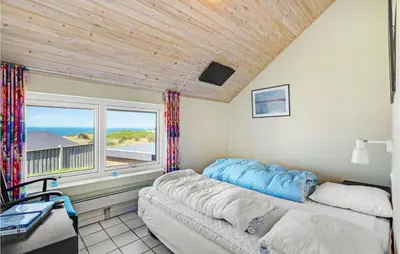 a bedroom with a bed and a large window at Stunning Home In Struer With Wifi in Struer