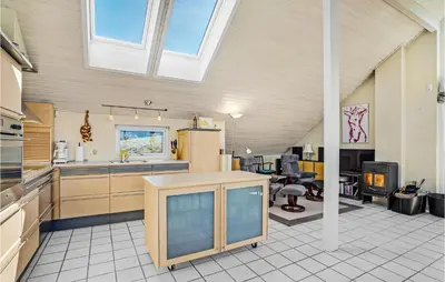 a kitchen with a refrigerator and a table in a room at Stunning Home In Struer With Wifi in Struer
