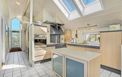 a kitchen with a vaulted ceiling with a skylight at Stunning Home In Struer With Wifi in Struer