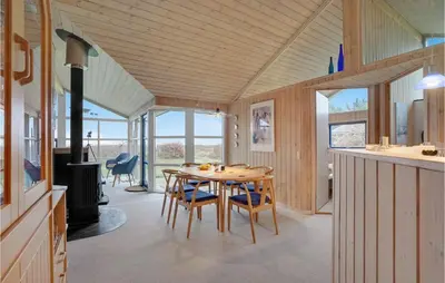 a kitchen and dining room with a table and chairs at Beautiful Home In Thyholm With Wifi in Thyholm