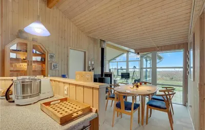 a kitchen and dining room with a table and chairs at Beautiful Home In Thyholm With Wifi in Thyholm