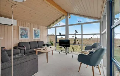 a living room with a couch and a table at Beautiful Home In Thyholm With Wifi in Thyholm