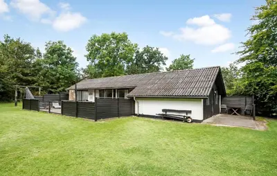 a house with a large yard with a shed at 3 Bedroom Awesome Home In Thyholm in Thyholm