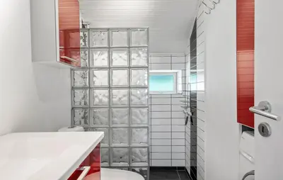 a bathroom with a glass block shower backdoor at 3 Bedroom Awesome Home In Thyholm in Thyholm