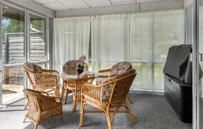 a dining room with a table and chairs and a television at 3 Bedroom Awesome Home In Thyholm in Thyholm