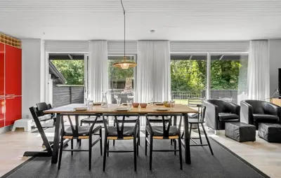 a dining room with a table and chairs at 3 Bedroom Awesome Home In Thyholm in Thyholm