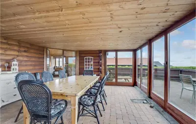 a dining room with a table and chairs at Gorgeous Home In Vinderup With Sauna in Vinderup
