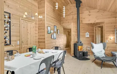 a dining room with a table and a fireplace at Gorgeous Home In Vinderup With Sauna in Vinderup