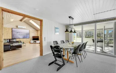 a dining room and living room with a table and chairs at Stunning Home In Vemb With Wifi in Vemb