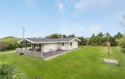a small white house with a large yard at 3 Bedroom Amazing Home In Hurup Thy in Sindrup