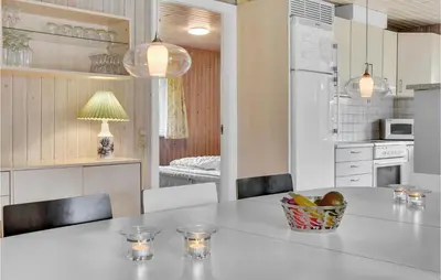 a kitchen with a table with a bowl of fruit on it at 3 Bedroom Amazing Home In Hurup Thy in Sindrup