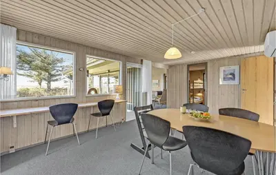 a dining room with a table and chairs at 3 Bedroom Gorgeous Home In Thyholm in Thyholm