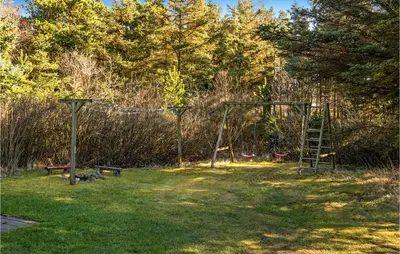a playground with a ladder and a swing set at 3 Bedroom Gorgeous Home In Thyholm in Thyholm