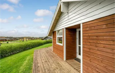 a house with a wooden walkway next to a building at Stunning Home In Vinderup With Sauna in Vinderup