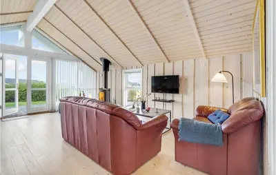 a living room with two leather chairs and a table at Stunning Home In Vinderup With Sauna in Vinderup