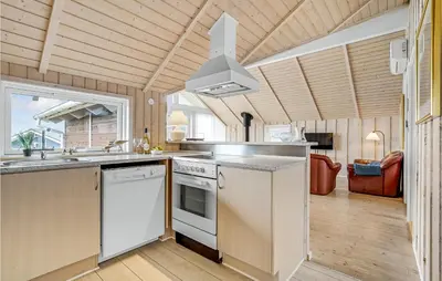 a kitchen with a sink and a stove top oven at Stunning Home In Vinderup With Sauna in Vinderup