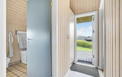a bathroom with a toilet and an open door at Stunning Home In Vinderup With Sauna in Vinderup