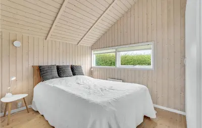 a bedroom with a white bed and a window at Stunning Home In Vinderup With Sauna in Vinderup