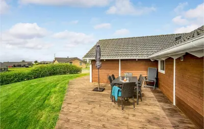 a patio with a table and chairs on it at Stunning Home In Vinderup With Sauna in Vinderup