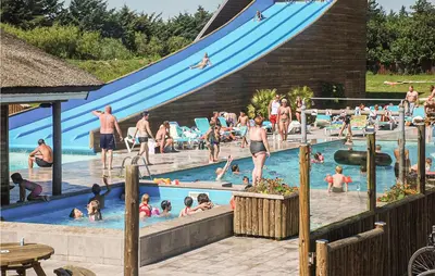 a group of people in a swimming pool with a slide at Cozy Home In Hanstholm With Wifi in Hanstholm
