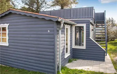 a blue house with a metal roof at Cozy Home In Hanstholm With Wifi in Hanstholm