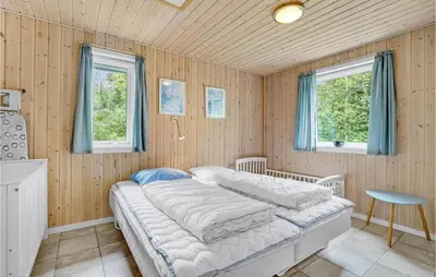a bedroom with a bed and two windows at 7 Bedroom Gorgeous Home In Vinderup in Vinderup