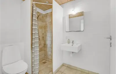 a white bathroom with a toilet and a sink at 7 Bedroom Gorgeous Home In Vinderup in Vinderup