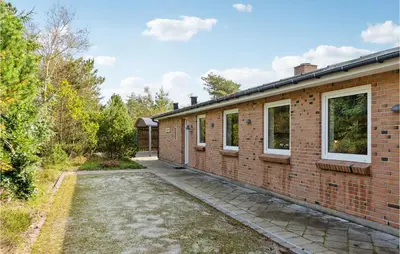 an exterior view of a brick building with a driveway at Lovely Home In Fjerritslev With Wifi in Fjerritslev