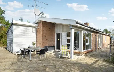 a patio with a table and chairs in front of a building at Lovely Home In Fjerritslev With Wifi in Fjerritslev