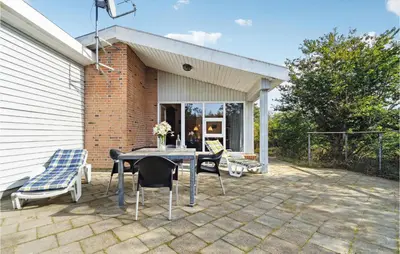 a patio with a table and chairs and a building at Lovely Home In Fjerritslev With Wifi in Fjerritslev