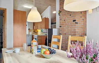 a kitchen with a wooden table with a bowl of fruit at Lovely Home In Fjerritslev With Wifi in Fjerritslev