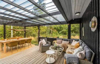 a screened in porch with a couch and a table at 3 Bedroom Nice Home In Hurup Thy in Sønder Ydby