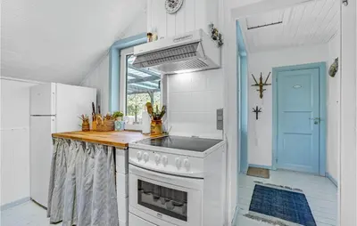 a kitchen with a white stove and a sink at 3 Bedroom Nice Home In Hurup Thy in Sønder Ydby