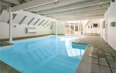 a swimming pool with blue water in a building at 4 Bedroom Lovely Home In Fjerritslev in Fjerritslev