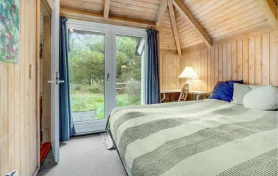 a bedroom with a bed and a large window at 4 Bedroom Lovely Home In Fjerritslev in Fjerritslev