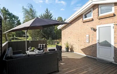 a patio with a table and an umbrella at Cozy Home In Fjerritslev With Wifi in Fjerritslev