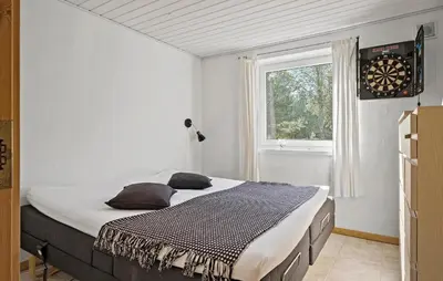 a bedroom with a large bed in front of a window at Cozy Home In Fjerritslev With Wifi in Fjerritslev