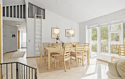 a dining room and living room with a table and chairs at Cozy Home In Fjerritslev With Wifi in Fjerritslev