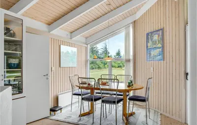 a dining room with a table and chairs and a window at 3 Bedroom Beautiful Home In Frøstrup in Frøstrup