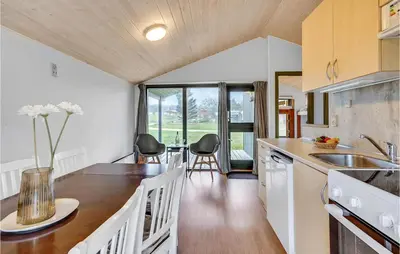 a kitchen with a table and chairs in a room at Lovely Home In Hanstholm With Wifi in Hanstholm