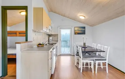 a kitchen and dining room with a table and chairs at Lovely Home In Hanstholm With Wifi in Hanstholm