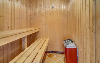 a wooden sauna with a trash can in it at Beautiful Home In Frøstrup With Sauna in Frøstrup