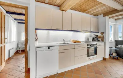 a kitchen with white cabinets and a sink at Beautiful Home In Frøstrup With Sauna in Frøstrup