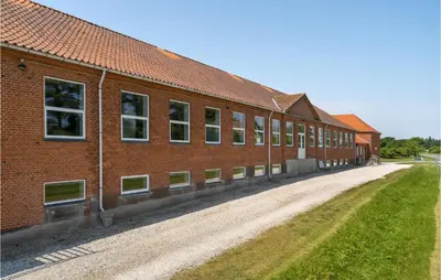 a brick building with a dirt road next to it at Stunning Home In Hanstholm With Sauna in Hanstholm