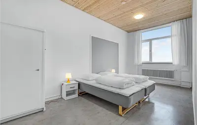 a white bedroom with a bed and a window at Stunning Home In Hanstholm With Sauna in Hanstholm