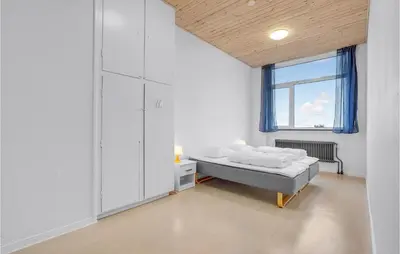 a white room with a bed and a window at Stunning Home In Hanstholm With Sauna in Hanstholm